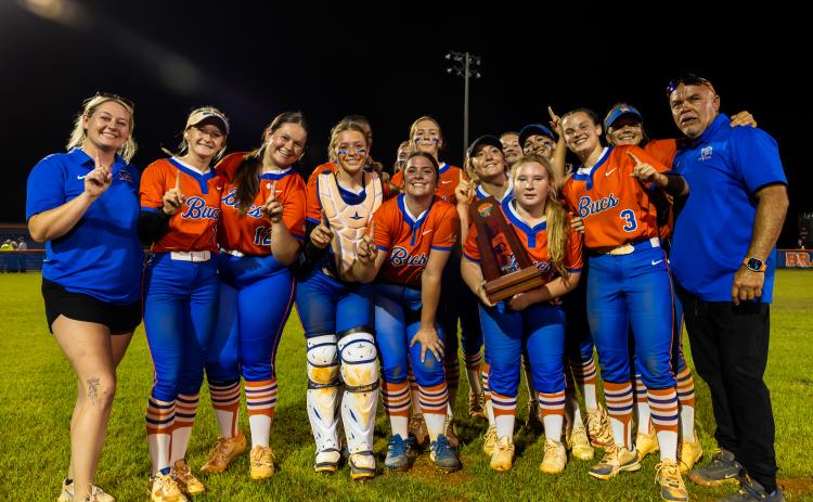 Branford's softball team poses with the District 6-R trophy after defeating Fort White 3-1 on Thursday. (JACK HOWDESHELL/Lake City Reporter)