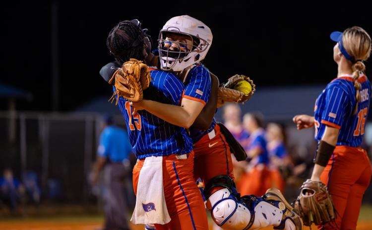 Branford catcher Morgan Brennan (right) celebrates with first baseman Mallory Blue (15) following the final out of the Buccaneers' 6-0 victory over Fort White in the Region 3-R semifinals on Thursday. (JACK HOWDESHELL/Lake City Reporter)