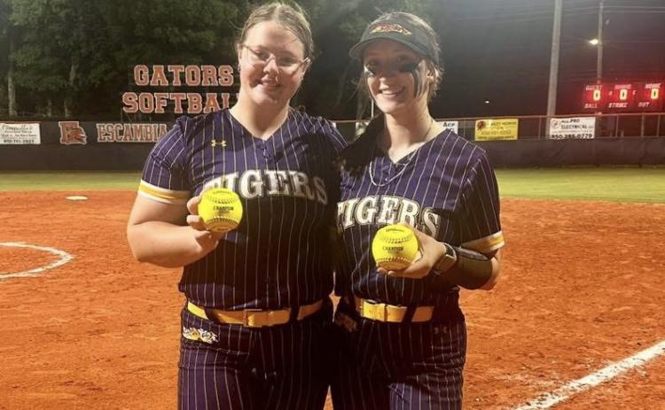 Columbia designated player Josie Raulerson (left) and catcher Emily Delgado show off their home run balls following the Tigers’ 16-0 win over Escambia in the Region 1-4A quarterfinals on Tuesday. (COURTESY)