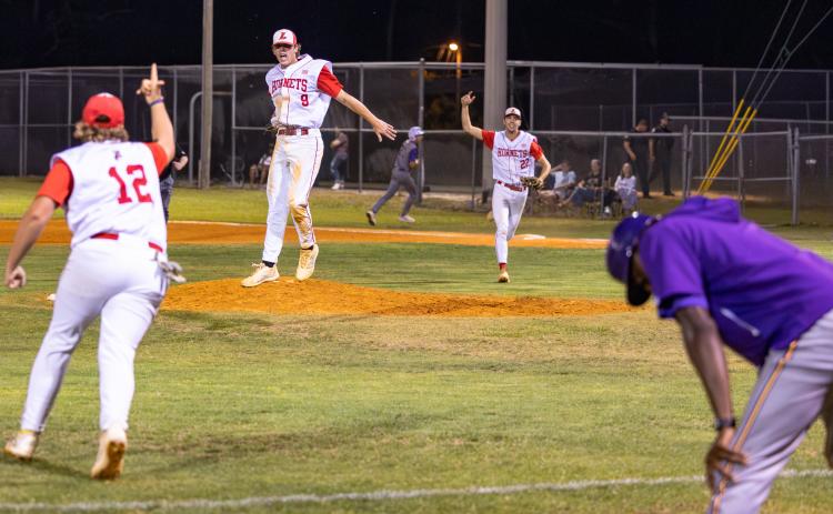 Lafayette pitcher Garrett Taylor (9), Harris Johnson (12) and first baseman Noah Lamb (22) celebrate after the Hornets’ game-ending double play that finished off a 2-1 win over Union County in Game 2 of the Region 3-R finals on Tuesday. (JACK HOWDESHELL/Lake City Reporter)