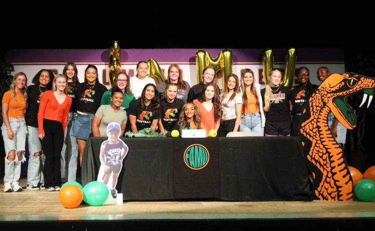 Columbia outfielder Sakiya Merriex (sitting) is surrounded by teammates after signing her letter of intent to play college softball at Florida A&M on Friday. (JORDAN KROEGER/Lake City Reporter)