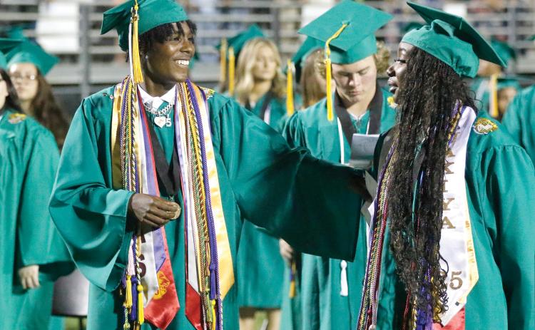 Suwannee graduates Joseph Alicea (left) and Jakiya Washington sing the alma mater during Saturday night’s commencement at Langford Stadium. (JAMIE WACHTER/Lake City Reporter)