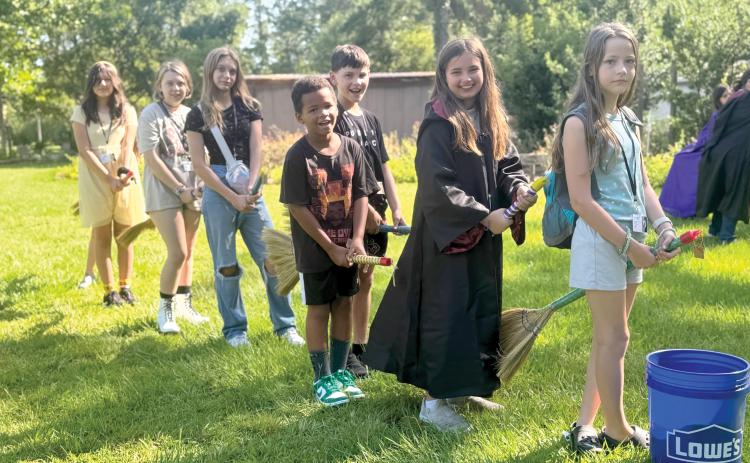 4-H campers Lumen Jimenez (from let), Amelia Mears, Kenleigh Markham, Carter Jordan, Emerson Coleman, Penelope Regar and Heaven Marton have broom practice in preparation for playing Quadball. (PHOTOS COURTESY UF/IFAS COLUMBIA COUNTY EXTENSION)