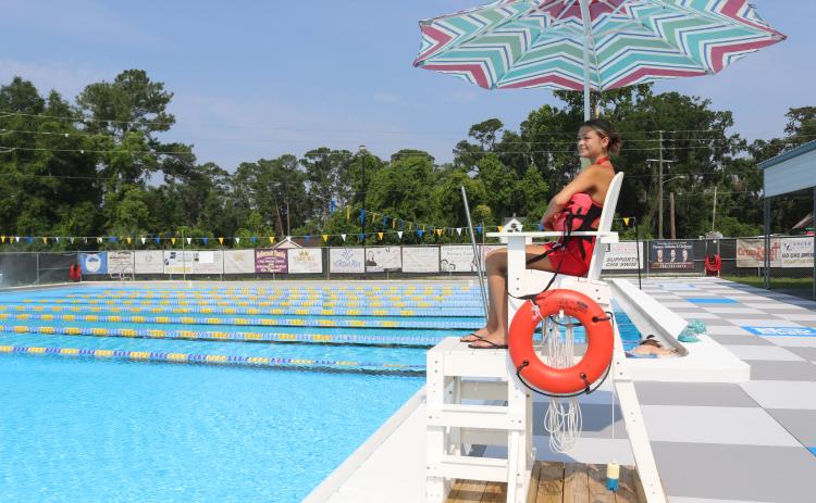 Emma Pitman, a lifeguard at the Jared Allison Aquatic Complex, watches over the pool Monday following a ribbon cutting for the revamped complex. (TONY BRITT/Lake City Reporter)