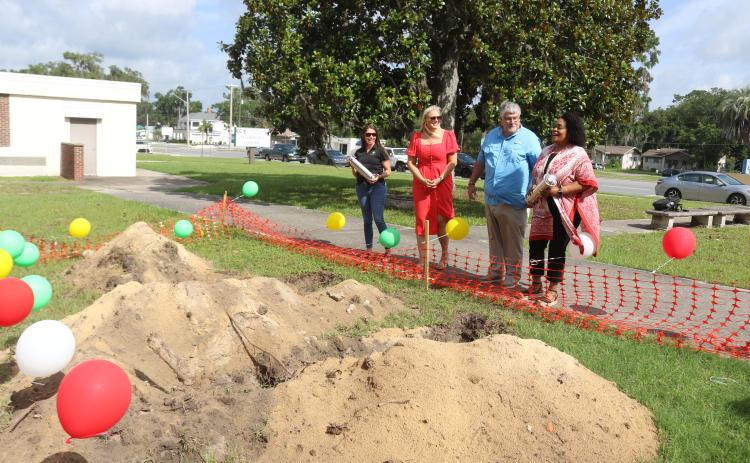 Five Points Elementary School Principal Brandi Keen (left) and Melrose Park Elementary School Principal Makeba Murphy (right) hold the time capsules prior to their burial as Columbia County Public Schools Foundation Director Dianna Swisher and Superintendent Keith Couey look on. (TONY BRITT/Lake City Reporter)