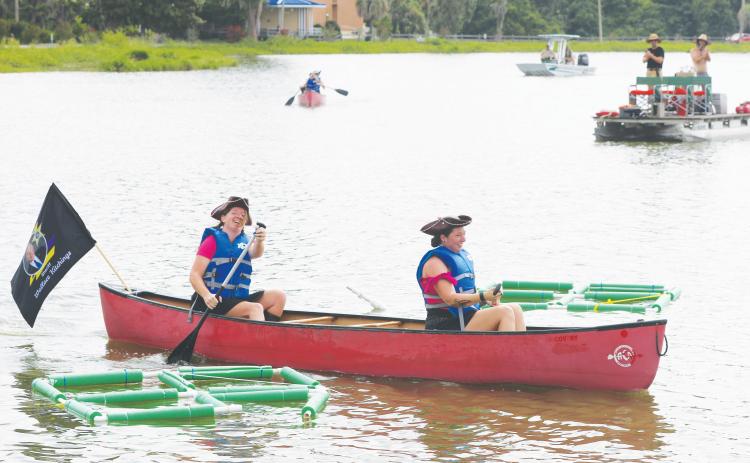 Ashlee Snowden (front) and Adair Bosserman are all smiles after winning the first heat during this year’s DeSoto Derby Canoe Races. The event was hosted by Elks Lodge #893. (TONY BRITT/Lake City Reporter)