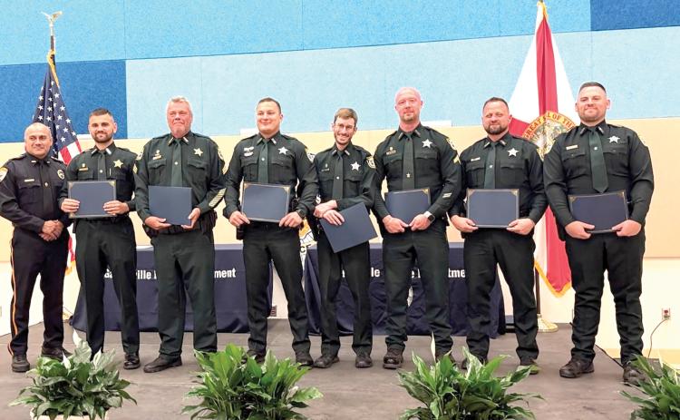 The Gainesville Police Department honored 12 Columbia County deputies and six communication officers on Friday with Police Service Awards for their help in capturing a fleeing murder suspect last year. (COURTESY)