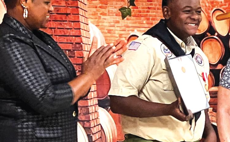 Josiah Jackson ‘JJ’ Kolwyck (right) receives a national Boy Scouts of America Award for saving a motorist during Hurricane Debby last summer. (COURTESY)