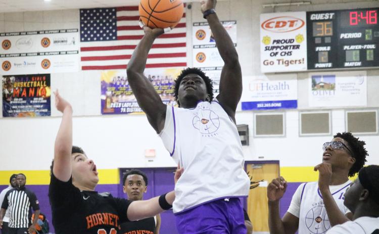 Columbia guard Alfonso Curry rises for a bucket against Hawthorne on Thursday. (JORDAN KROEGER/Lake City Reporter)