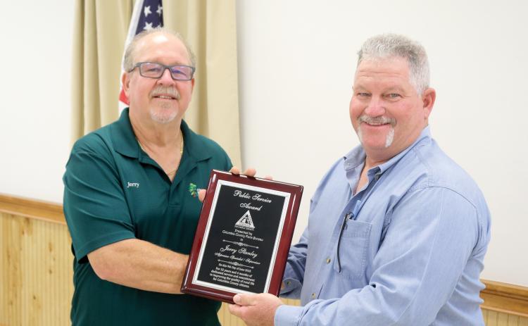 Jerry Stanley (left) was honored with the Public Service Award at the Columbia County Farm Bureau public officials appreciation dinner Monday night. Stanley is presented his plaque by Clint Pittman. (TONY BRITT/Lake City Reporter)