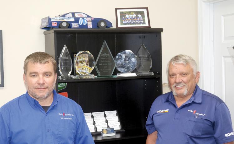 Donald Hollingsworth (right) opened up Holly Electric 30 years ago with help from his family. His son, Donald II (left), is now an equal partner in the Lake City-based business. (TONY BRITT/Lake City Reporter)