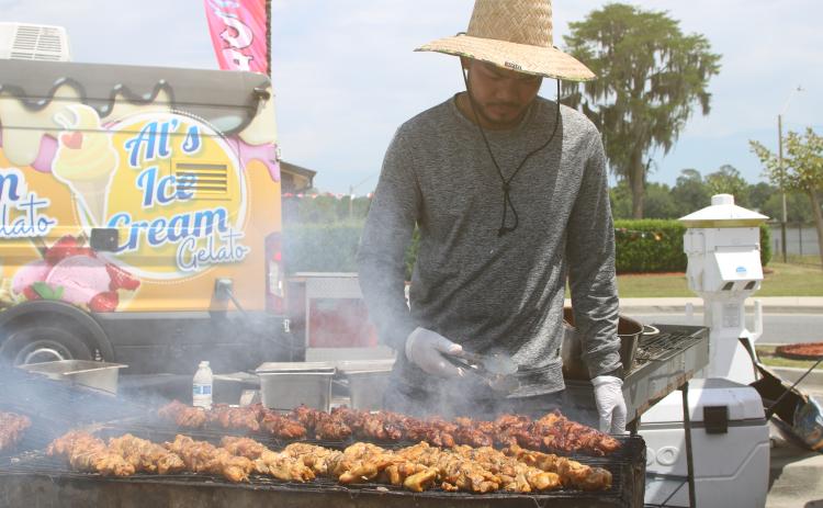 Auman Tamesis of Maya’s Merienda tends a variety of Filipino street food on the grill during the inaugural Multicultural Fiesta last year. The City of Lake City’s second Multicultural Day celebration is set for Saturday. (FILE)
