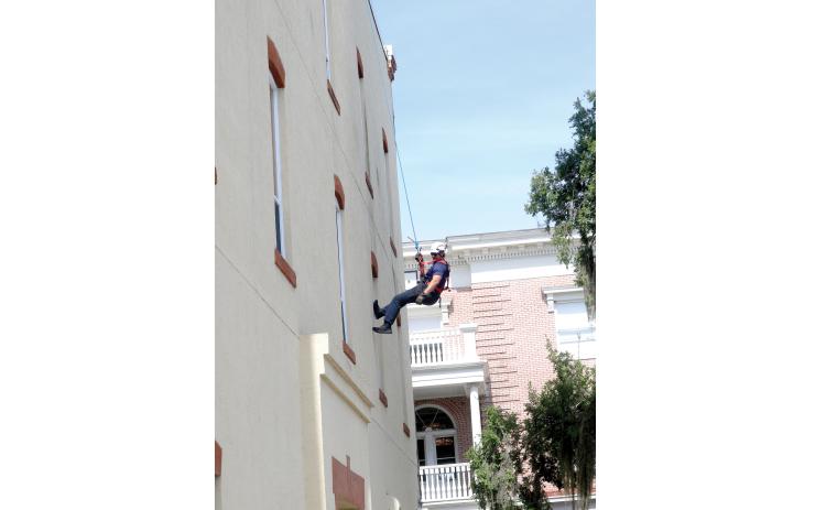 Lake City firefighter Matt Herndon rappels off the side of Lake City Hall during a training session Friday morning. (TONY BRITT/Lake City Reporter)