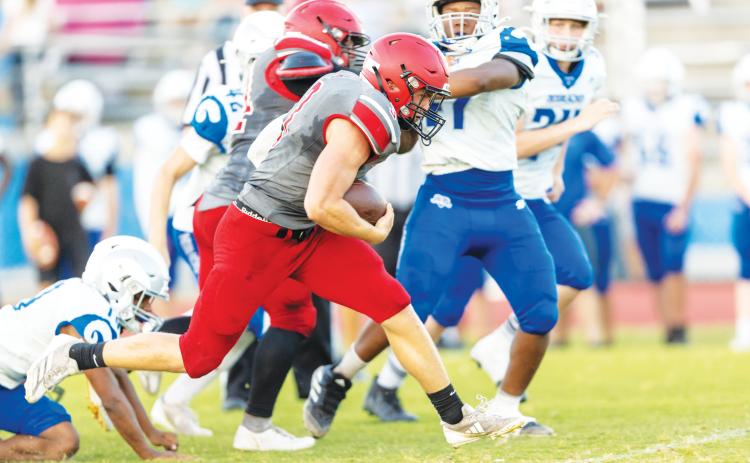 Lafayette running back Dayne McCray gains a chunk of yardage against Keystone Heights during their spring jamboree on May 20. (JACK HOWDESHELL/Lake City Reporter)