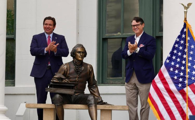 Florida Gov. Ron DeSantis (left) and Secretary of State Cord Byrd applaud the unveiling of a statue of Thomas Jefferson in Jefferson County on Wednesday as part of a new initiative to acquire statues of different counties’ namesakes. (COURTESY)