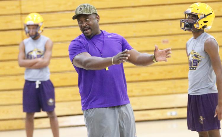Columbia coach Brian Allen coaches during Monday’s practice, which was forced into the gym due to extreme heat. (JORDAN KROEGER/Lake City Reporter)