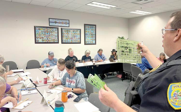 Sgt. Mike Lee with the Lake City Police Department shows members of a previous Citizen’s Police Academy the techniques used in investigating a traffic accident. (COURTESY)