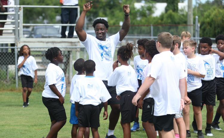 Jaquez Moore gathers campers together during his football camp on Saturday. (PAUL BUCHANAN/Lake City Reporter)