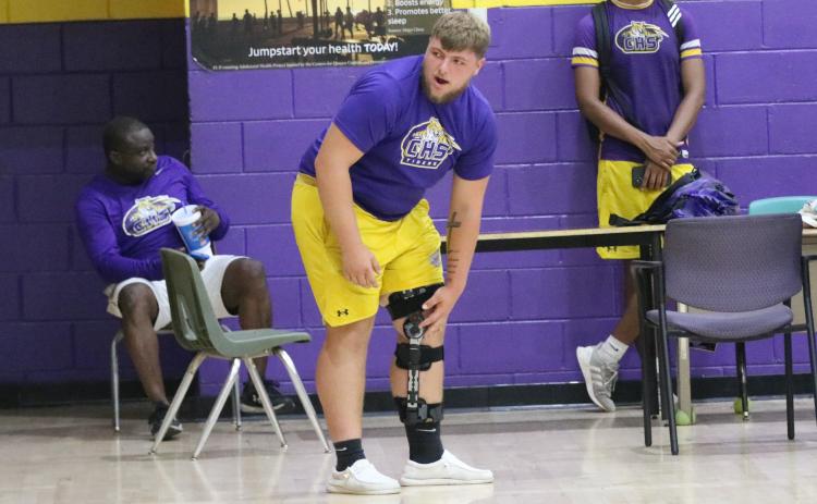 Columbia center Zackery Grimes watches practice inside the CHS gym on Monday after he recovers from tears to his ACL, MCL and meniscus in his knee. (JORDAN KROEGER/Lake City Reporter)