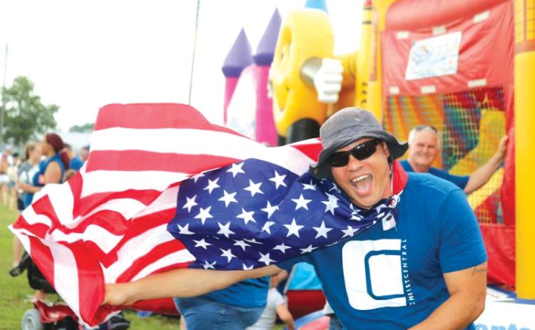 Earnest Burch waved down festival-goers with his Old Glory cape at the 2019 Independence Day event at the Columbia County Fairgrounds. (FILE)