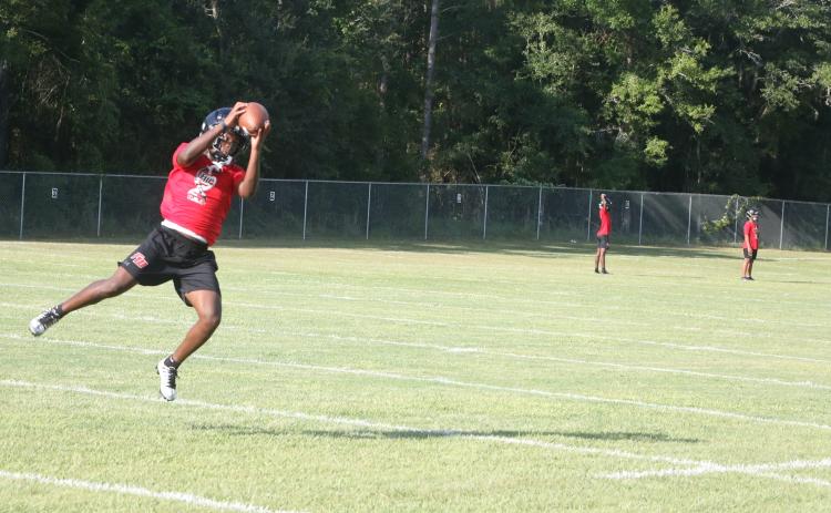 Fort White running back Elijah Gardner leaps to make a catch on a crossing route during Monday’s practice. (MORGAN MCMULLEN/Lake City Reporter)