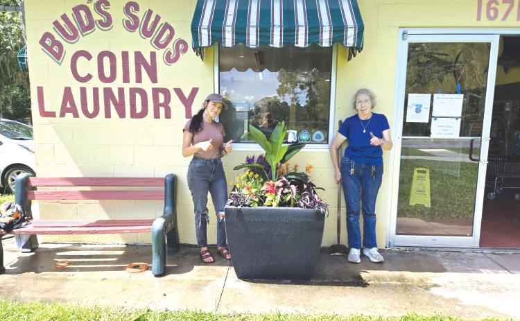 Hamilton County Director of Tourism Mia Hunter Mauldin (left) and Carol Stob, the owner of Bud’s Suds, pose next to a finished planter. (COURTESY)
