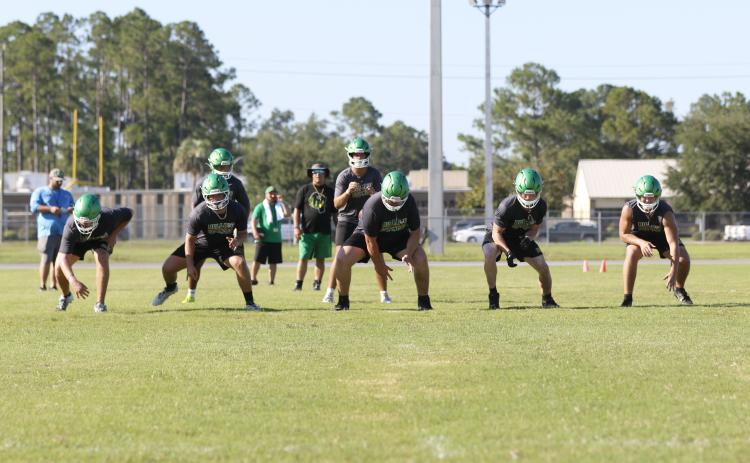 Suwannee quarterback Thomas Sikes gets set to take a snap behind offensive linemen Dalton Crossno (from left), Brody Bean, Blayne Crews, Reese Bronson and Colton Hagedorn during Monday's practice. (JAMIE WACHTER/Lake City Reporter)