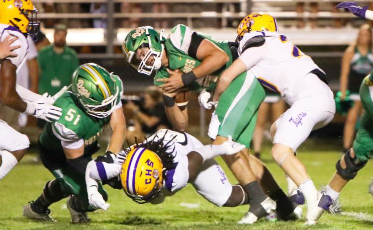 Suwannee quarterback Thomas Sikes is wrapped up by Columbia linebacker Bryson Grinstead on Friday night at Langford Stadium. (BRENT KUYKENDALL/Lake City Reporter)