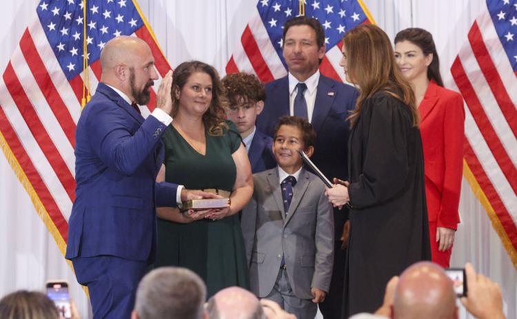 Jay Collins, a former Green Beret and decorated veteran, left, is sworn in as Florida’s new lieutenant governor by Florida Supreme Court Justice Jamie Grosshans on Tuesday in Tampa. He is joined by his wife, Layla, and their sons, Gabe and Colt. At right, Florida Gov. Ron DeSantis stands with his wife, Casey DeSantis. (DOUGLAS CLIFFORD/Tampa Bay Times/TNS)
