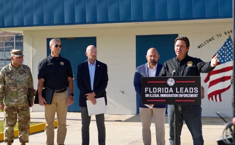 Gov. Ron DeSantis announces the creation of the ‘Deportation Depot’ immigrant detention center at Baker Correctional Institution in Sanderson on Thursday along with other state officials. The state prison’s proximity to the Lake City Gateway Airport was a key component in its selection for the site. (COURTESY)
