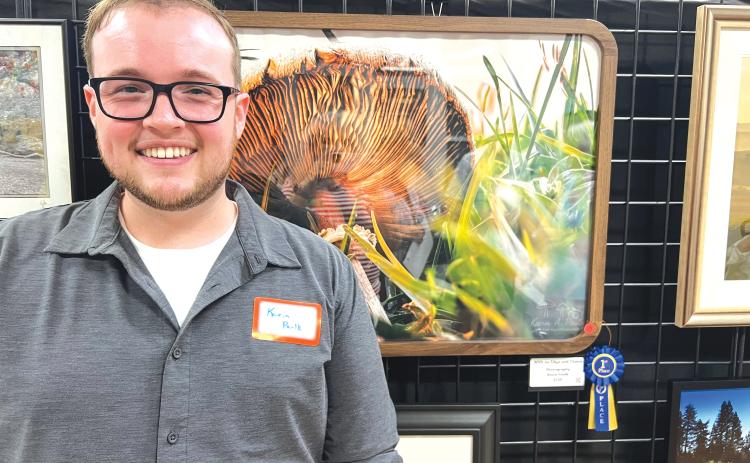 Kevin Paulk stands in front of his winning photograph, ‘With an Edge & Charm,’ during Saturday’s photo contest reception hosted at the Gateway Art Gallery. Paulk won a $125 cash prize in the second contest put on by the Branford Camera Club. (COURTESY)