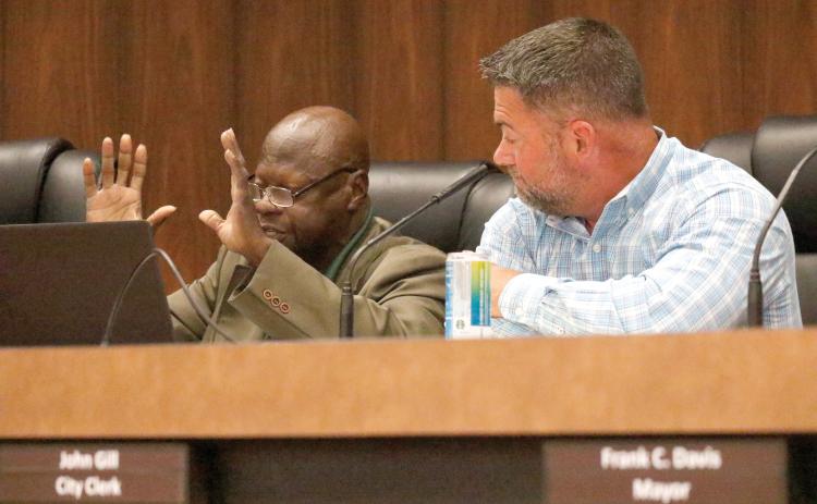 Live Oak City Council President Matt Campbell (right) looks on as County President Pro-Tem Tommie Jefferson speaks Tuesday during a budget workshop about the need for funding to pave streets in his district, including Spruce Street. (JAMIE WACHTER/Lake City Reporter)