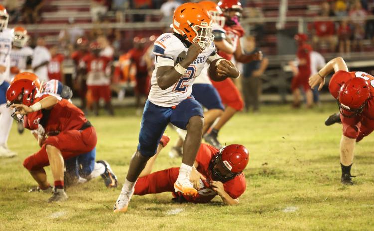 Branford running back Ollie James runs past a Dixie County defender Friday night during their Preseason Classic. (PAUL BUCHANAN/Lake City Reporter)