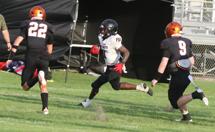 Fort White receiver John’l Lawson runs up field after a catch against Trenton during last week’s Preseason Classic. (MORGAN MCMULLEN/Lake City Reporter)