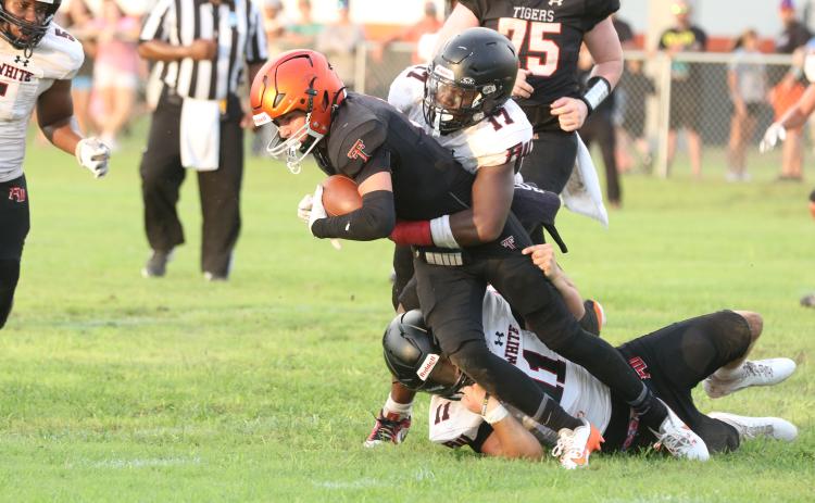 Fort White linebackers Cameron Lumpkin (17) and Teagin Bell (11) combine for a tackle on Trenton running back Brant Bivens during Friday’s Preseason Classic. (MORGAN MCMULLEN/Lake City Reporter)