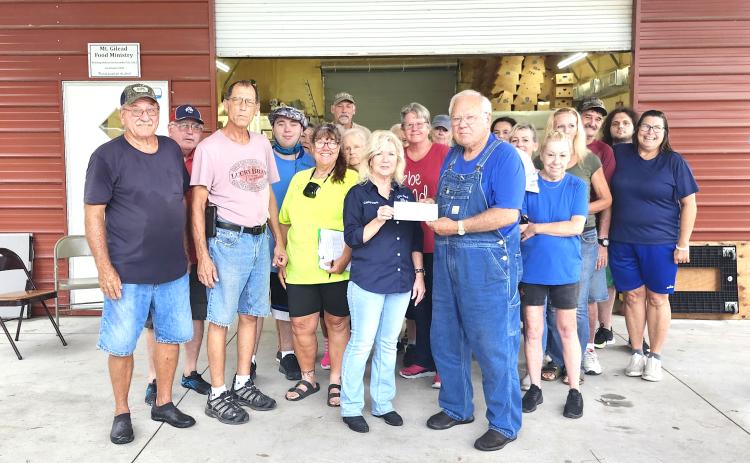 Members of Live Oak Elks Lodge #1165, Lori Watson (Lodge Grant Coordinator), Donald Watson (Past District Deputy) and Cathy Davis (Exalted Ruler) met at the Mt. Gilead Baptist Church Food Ministry in Falmouth on Saturday to present a $,6000 check from the Elks National Foundation Spotlight Grant to Gary Watson, food ministry founder/manager, and his team of volunteers. (COURTESY)