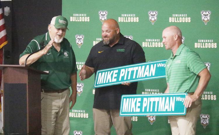 Legendary former Suwannee coach Mike Pittman was surprised at Friday’s celebration with the naming of the road adjacent to Langford Stadium as Mike Pittman Way. Pittman is pictured with SHS assistants Clifford Bean and Todd Frier, who both played under Pittman. (JAMIE WACHTER/Lake City Reporter)