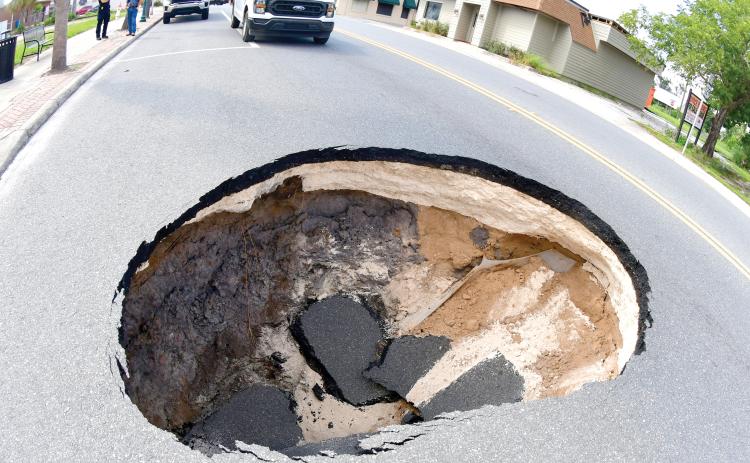 A sinkhole opened up Monday afternoon in the eastbound lane of E. Howard Street (U.S. Highwy 90) in downtown Live Oak near the intersection with Dowling Avenue. Florida Department of Transporation crews repaired the problem Monday night and the street has been reopened. (ROB WOLFE/Lake City Reporter)