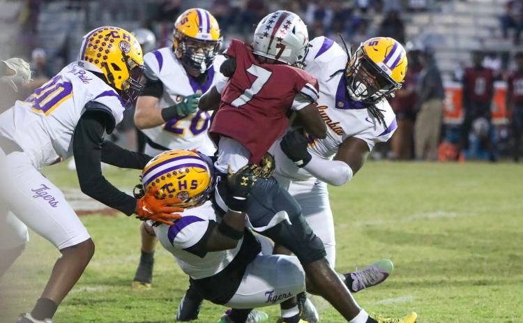 Columbia defensive linemen Jaylen Underwood (right) and Terry Henry (bottom) stuff Madison County running back Davyon Gallon on Friday night at Boot Hill. (BRENT KUYKENDALL/Lake City Reporter)