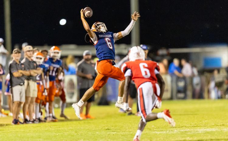 Branford running back TC Smith makes a leaping one-handed grab on fourth down against Hilliard on Friday. (JACK HOWDESHELL/Lake City Reporter)