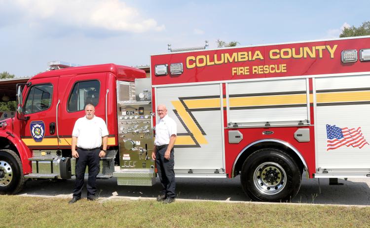 Columbia County Assistant Fire Chief Lance Hill (rom left) and Fire Chief Jeff Crawford look over the county’s newest fire truck that arrived Thursday. The truck, which was purchased for $480,393, is an Advanced Life Support unit, capable of pumping 1,250 gallons of water per minute and carries 1,000 gallons of water and can haul five firefighters. (TONY BRITT/Lake City Reporter)