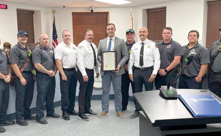 Members of the Lake City Fire Department, including Chief Josh Wehinger and Assistant Chief Rhet Tompkins, receive a proclamation from Mayor Noah Walker at Monday’s Lake City Council meeting for Firefighter Appreciation Month. (COURTESY CITY OF LAKE CITY)