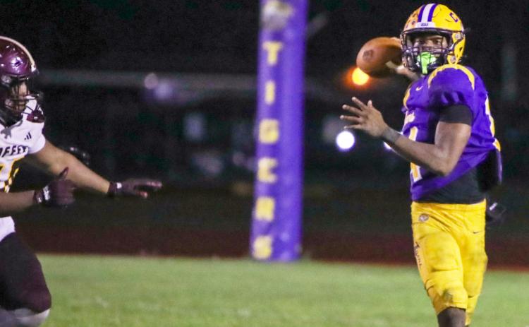 Columbia quarterback Xavier Collins rolls out to pass against Coffee last Friday. (BRENT KUYKENDALL/Lake City Reporter)