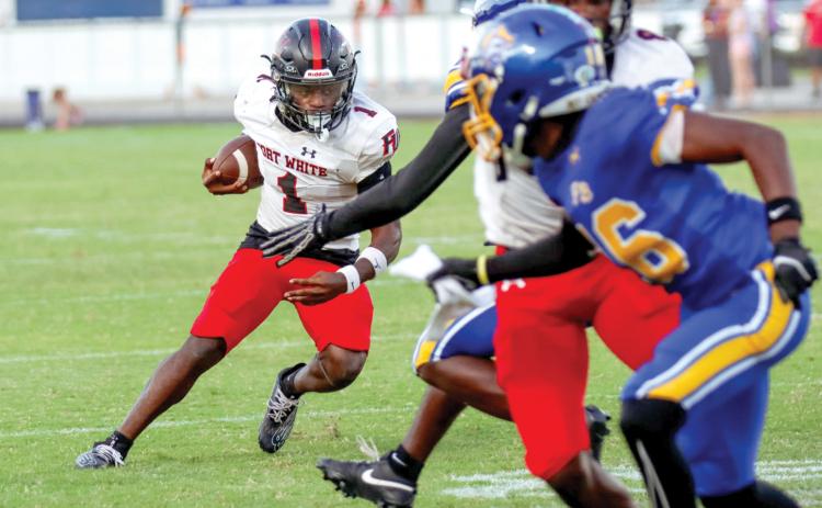 Fort White running back John’l Lawson looks for room to run Friday night against Fernandina Beach. (ASHLEY CHANDLER/Fernandina Beach News-Leader)