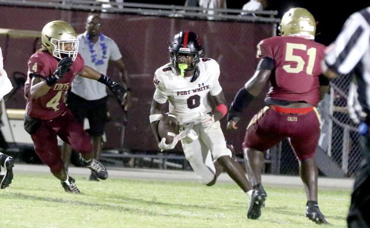 Fort White receiver Jayden Jackson looks for a lane on a sweep play Friday against North Marion. (MORGAN MCMULLEN/Lake City Reporter)