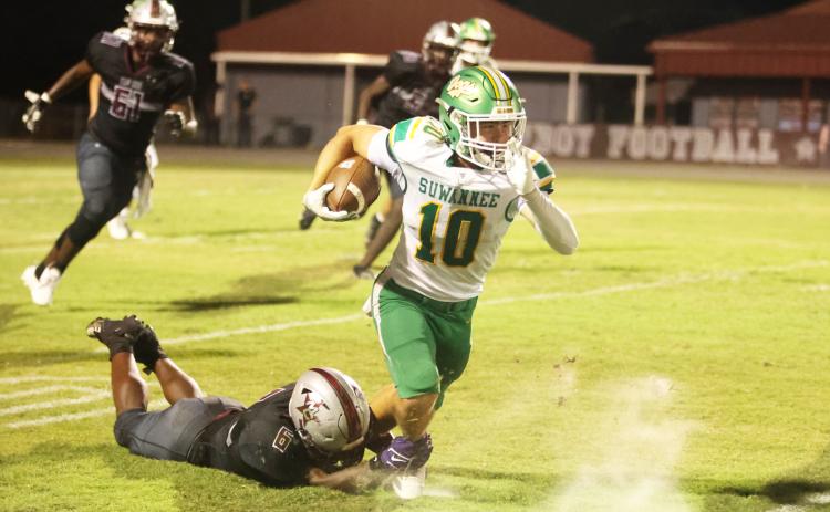 Suwannee receiver Koy Frier is tackled from behind by Madison County defensive end Brandon Williams on Friday. (PAUL BUCHANAN/Lake City Reporter)
