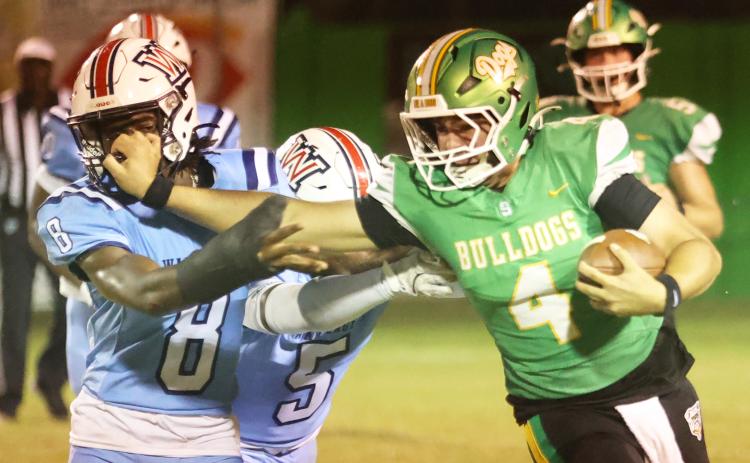Suwannee quarterback Thomas Sikes stiff-arms Wakulla’s Rayshon St. Hilaire on a run Friday night. (PAUL BUCHANAN/Lake City Reporter)