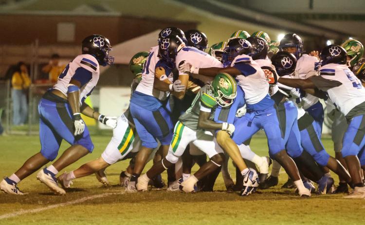 Godby quarterback Landon Dougherty reaches for the end zone as teammates push behind him Friday night at Langford Stadium. Suwannee’s Jayden Polite tries to hold him up. (PAUL BUCHANAN/Lake City Reporter)