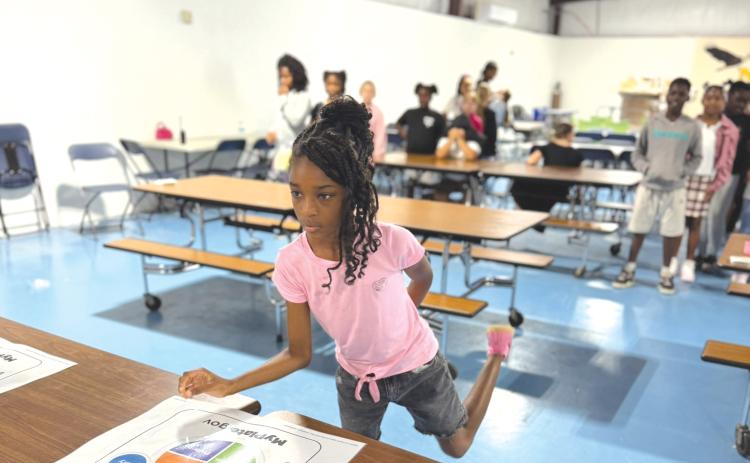 Niblack Elementary students participated in a Food Group Relay in which students such as Julianna Thomas, practiced sorting foods into the correct groups. (COURTESY)