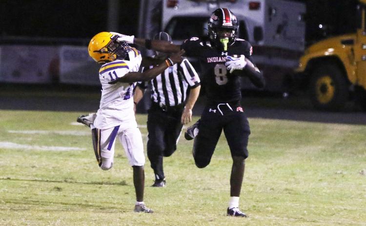 Fort White’s Jayden Jackson stiff-arms Union County defensive back Natwan Richardson during a punt return in Friday’s 47-0 win. (MORGAN MCMULLEN/Lake City Reporter)